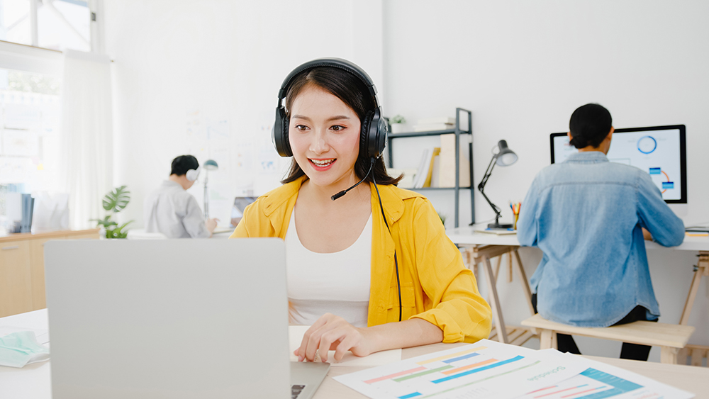 asia businesswoman social distancing new normal situation virus prevention while using laptop presentation colleagues about plan video call while work office life after corona virus