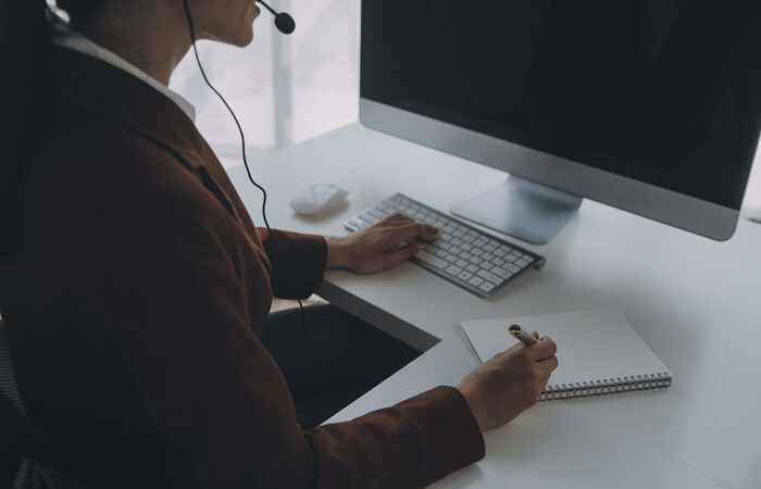 beautiful female call center operator working computer office