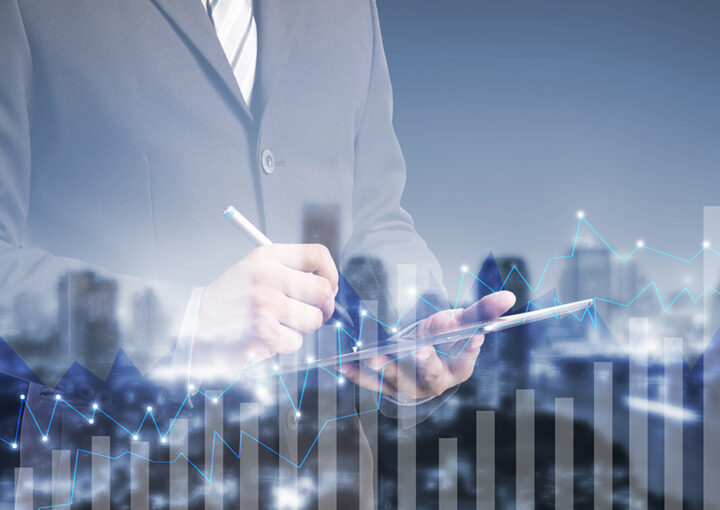 double exposure businessman using digital tablet by graph cityscape